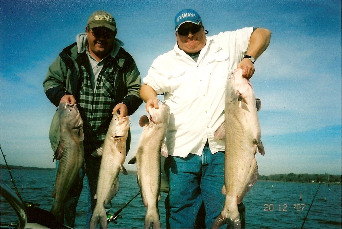 Two men each holding two large fish caught in Lake Limestone TX